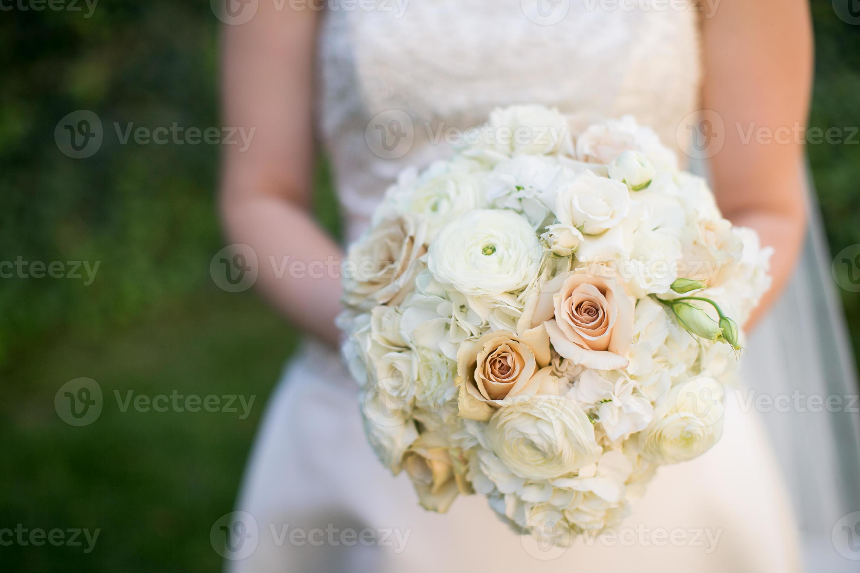 Wedding bouquet with Ranunculus, Roses, Hydrangea, and Lisianthus