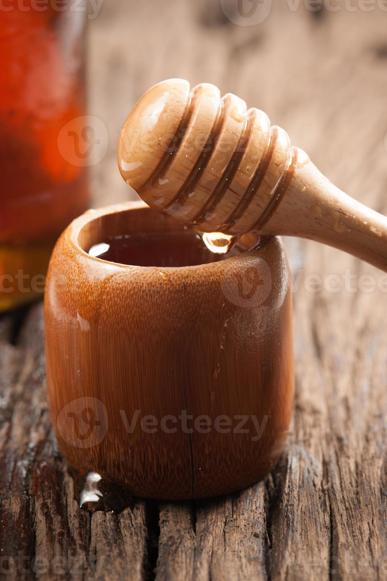 Fresh natural honey in a jar with honey spoon 1263034 Stock Photo at Vecteezy