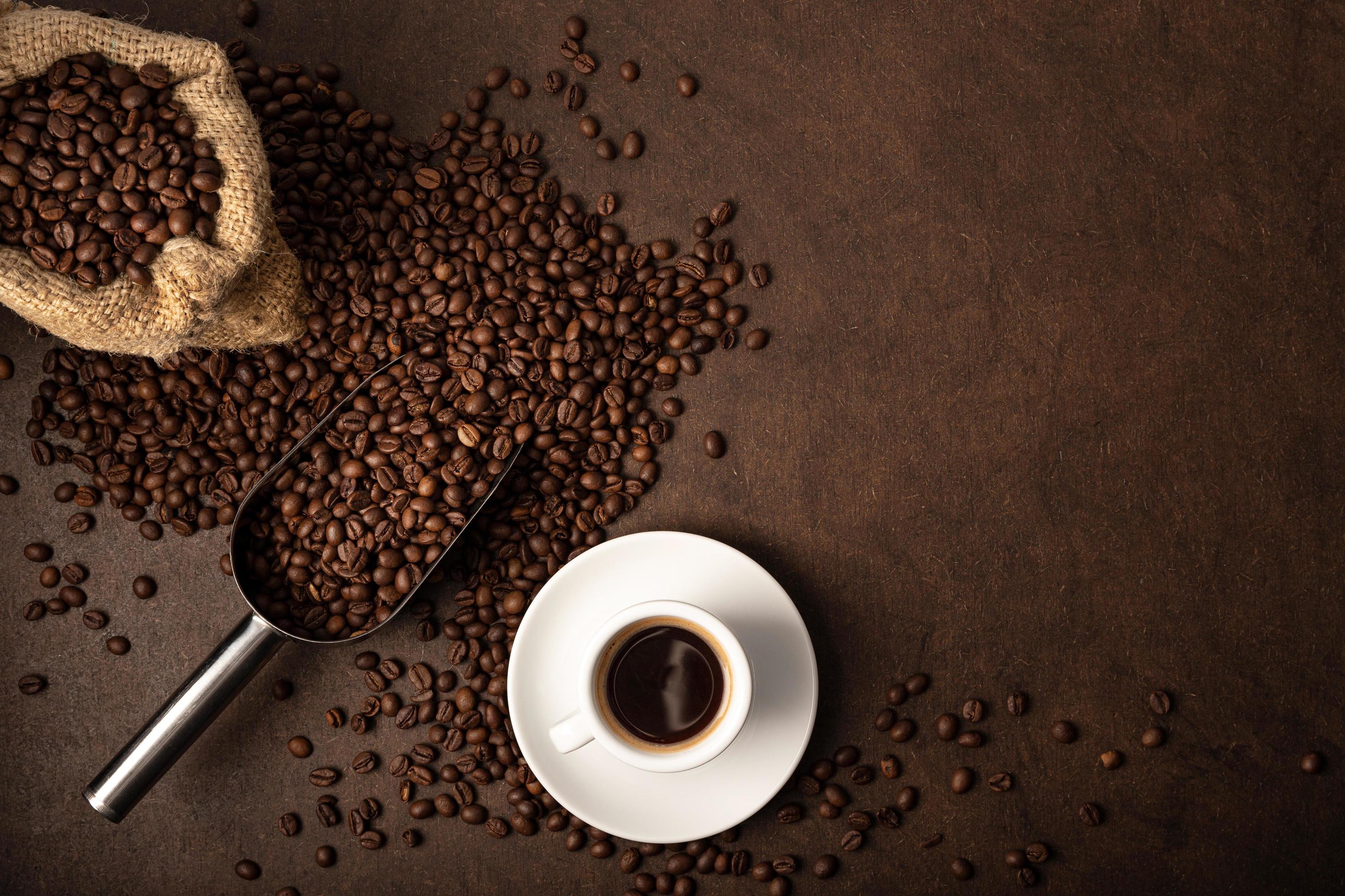 Cup Of Coffee And Scoop On Brown Background Stock Photo Cup Of Coffee And Scoop On Brown Background Stock Photo