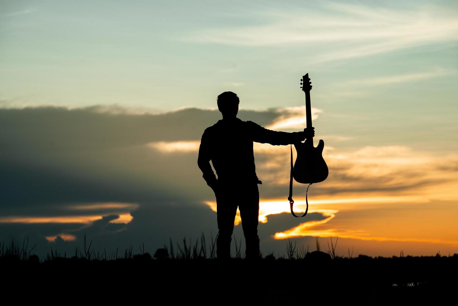 Silhouette of musician with guitar  photo