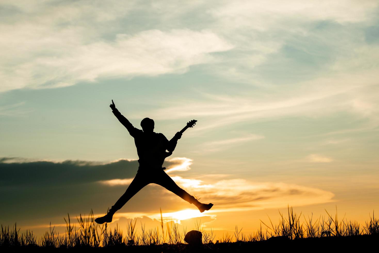 Musician man jumps while playing photo