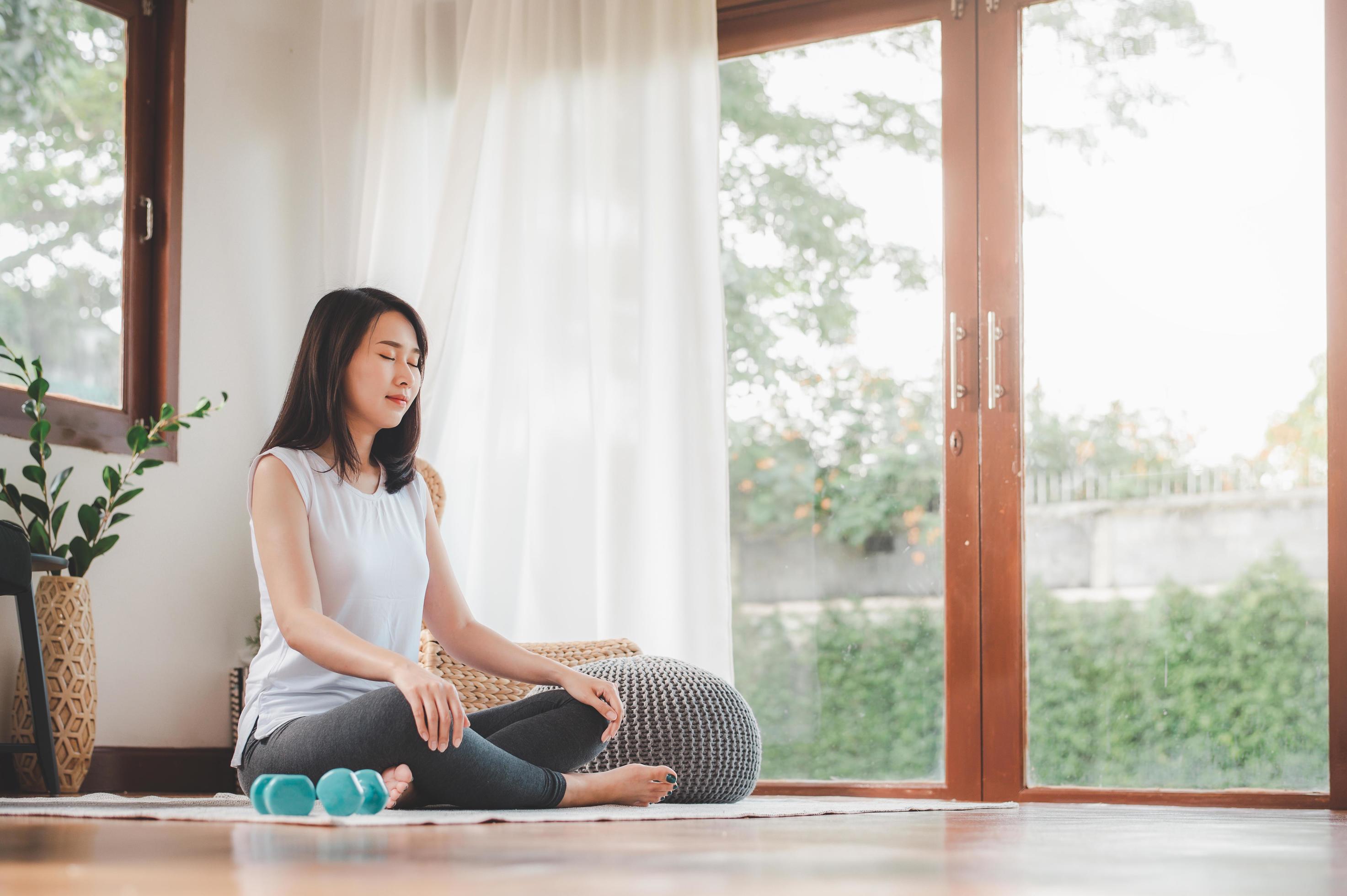 Asian woman doing yoga meditation 1264121 Stock Photo at Vecteezy