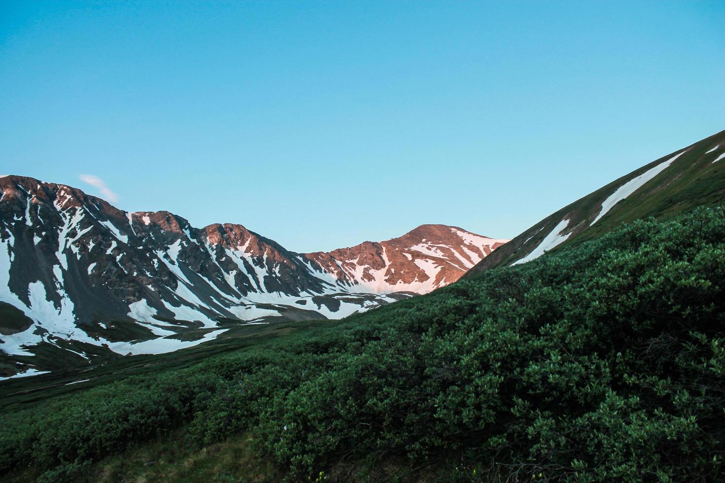 Sunlight on snowy mountain range  photo