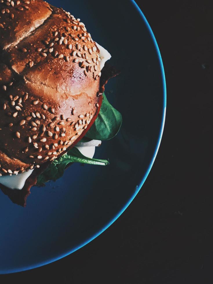 Burger on blue ceramic plate photo