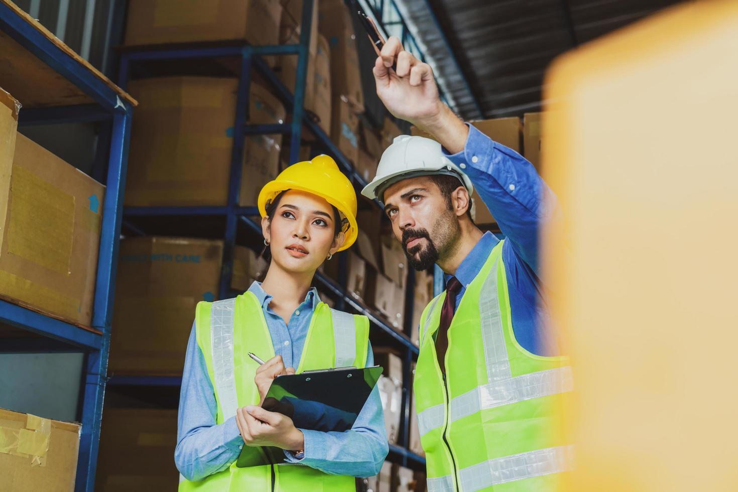 Manager of warehouse and worker in local warehouse photo