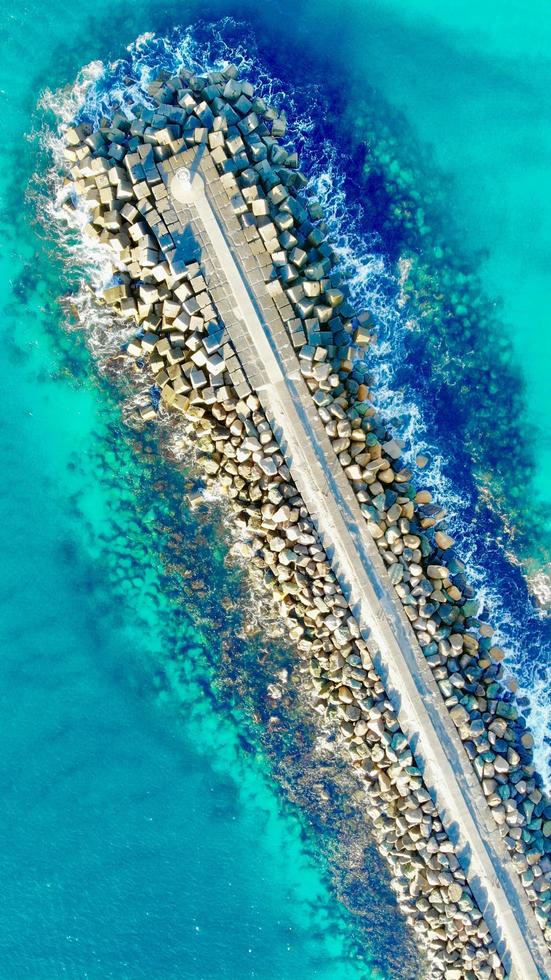 Concrete dock surrounded by water photo