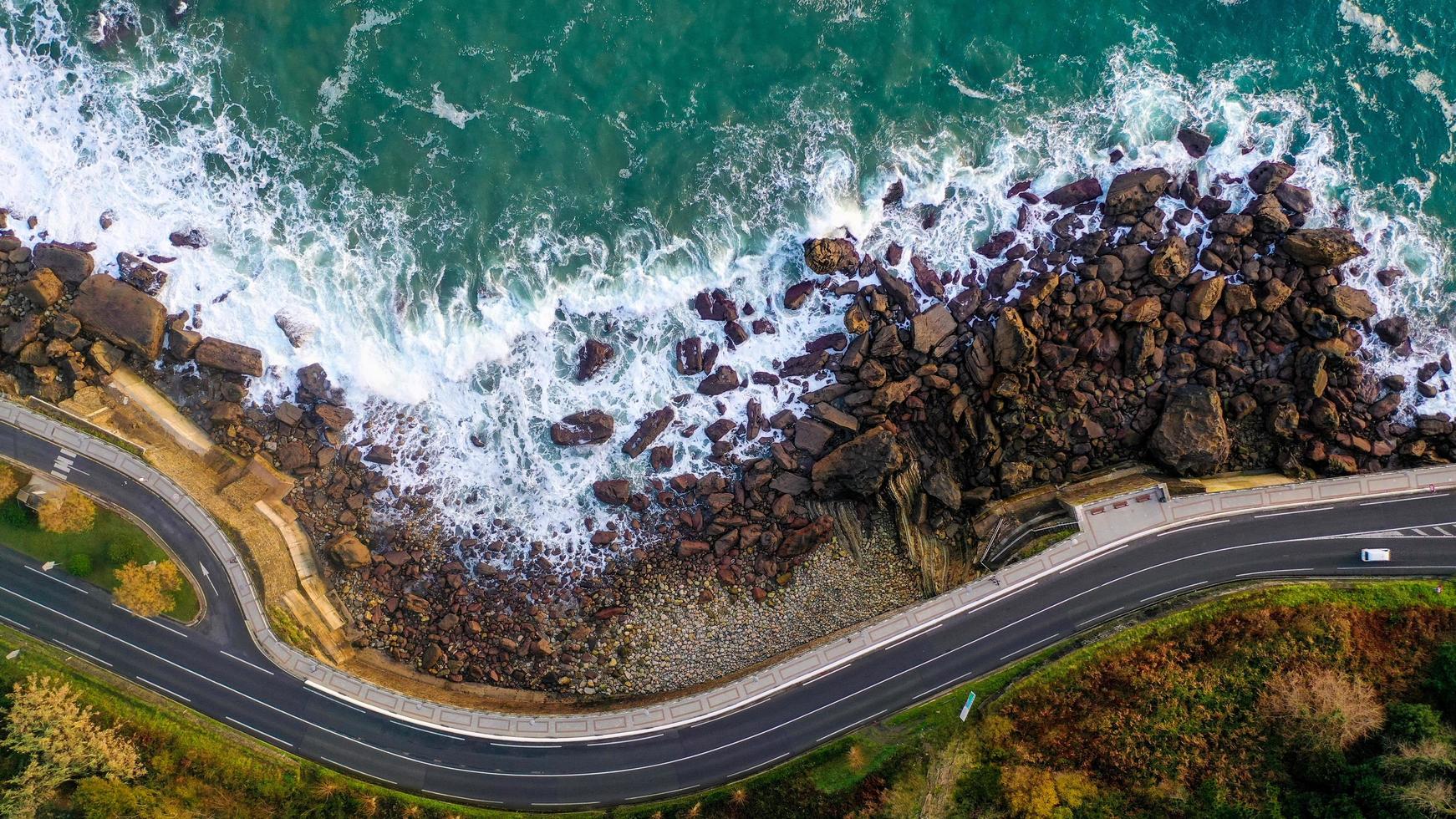 Aerial view of the seashore and a road photo