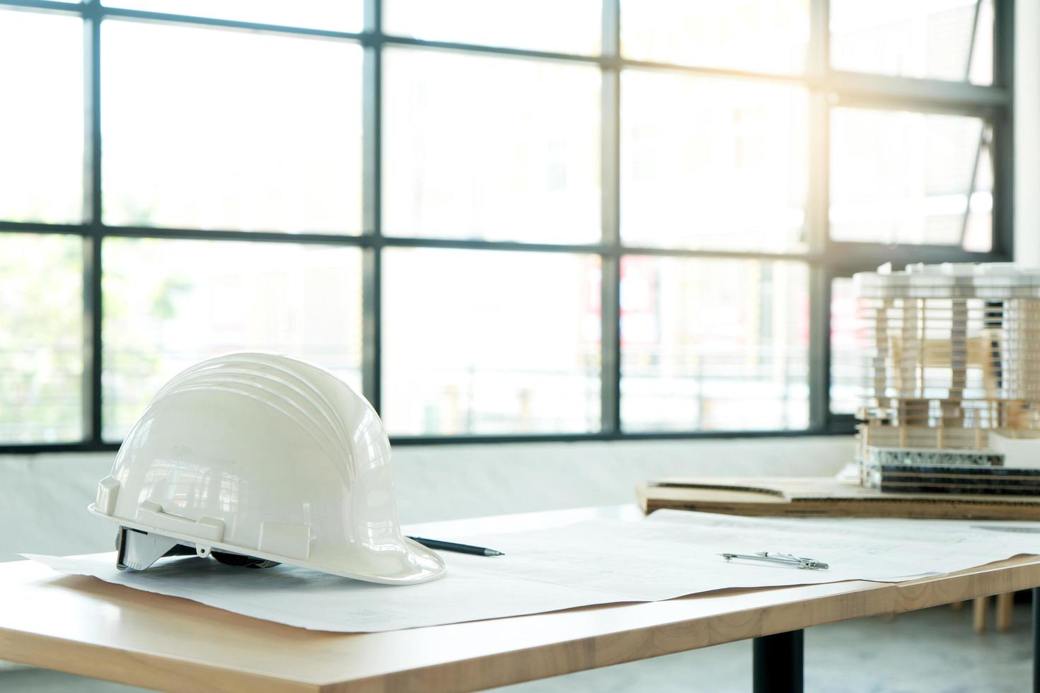 Hardhat and blueprint on table photo