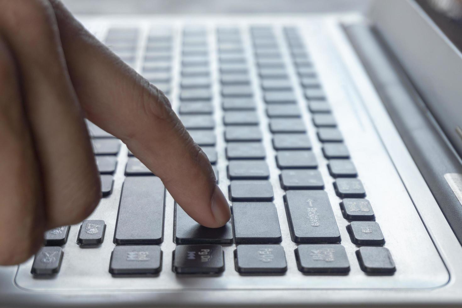 Close-up of fingers using keyboard photo