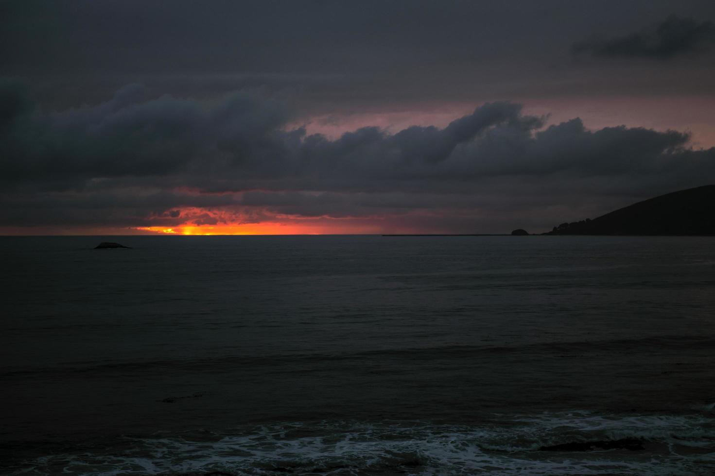 Body of water under cloudy sky  photo