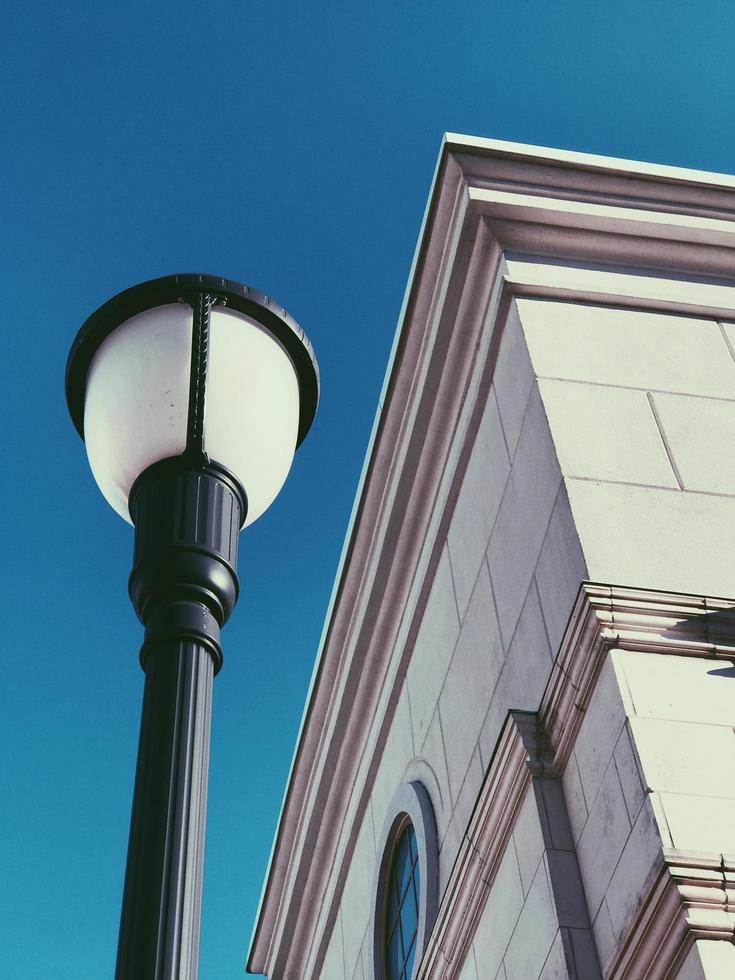 Low angle view of city lamp post and building photo