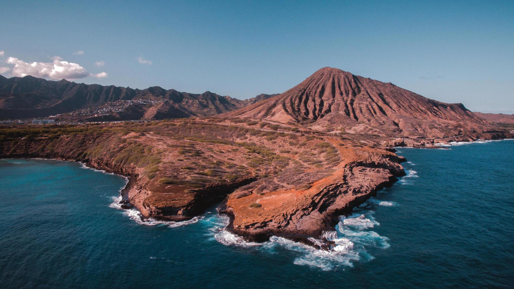 Brown rock formation in the sea photo