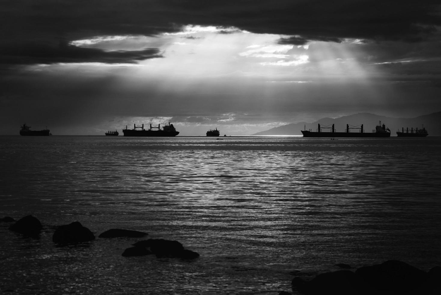 Grayscale of ships on water photo