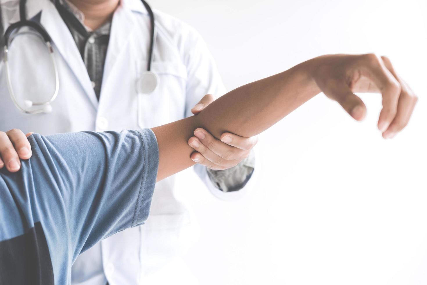 Doctor checking patient' elbow  photo