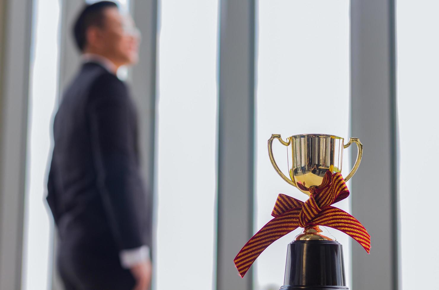 Businessman posing near an award photo