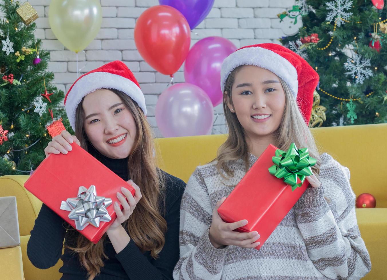 Two women holding Christmas presents photo