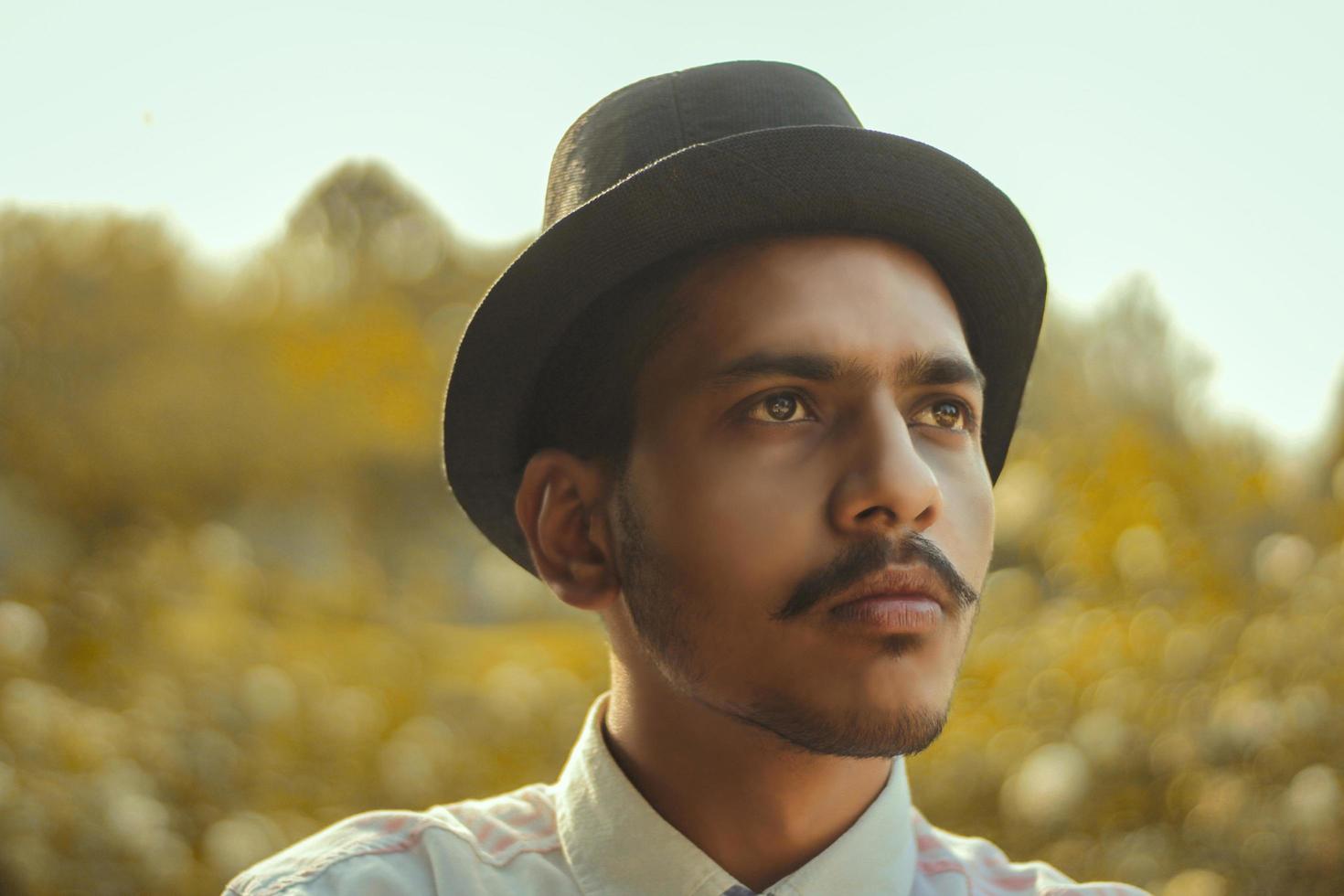 Young man wearing round hat photo