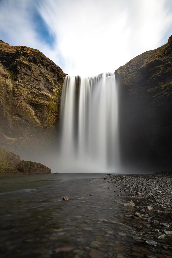 Waterfall on rocky mountain in Iceland photo