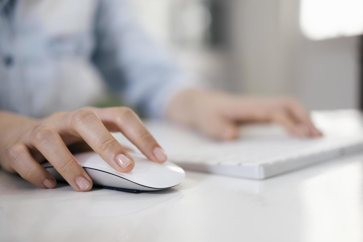 Close-up of a woman using a computer mouse photo