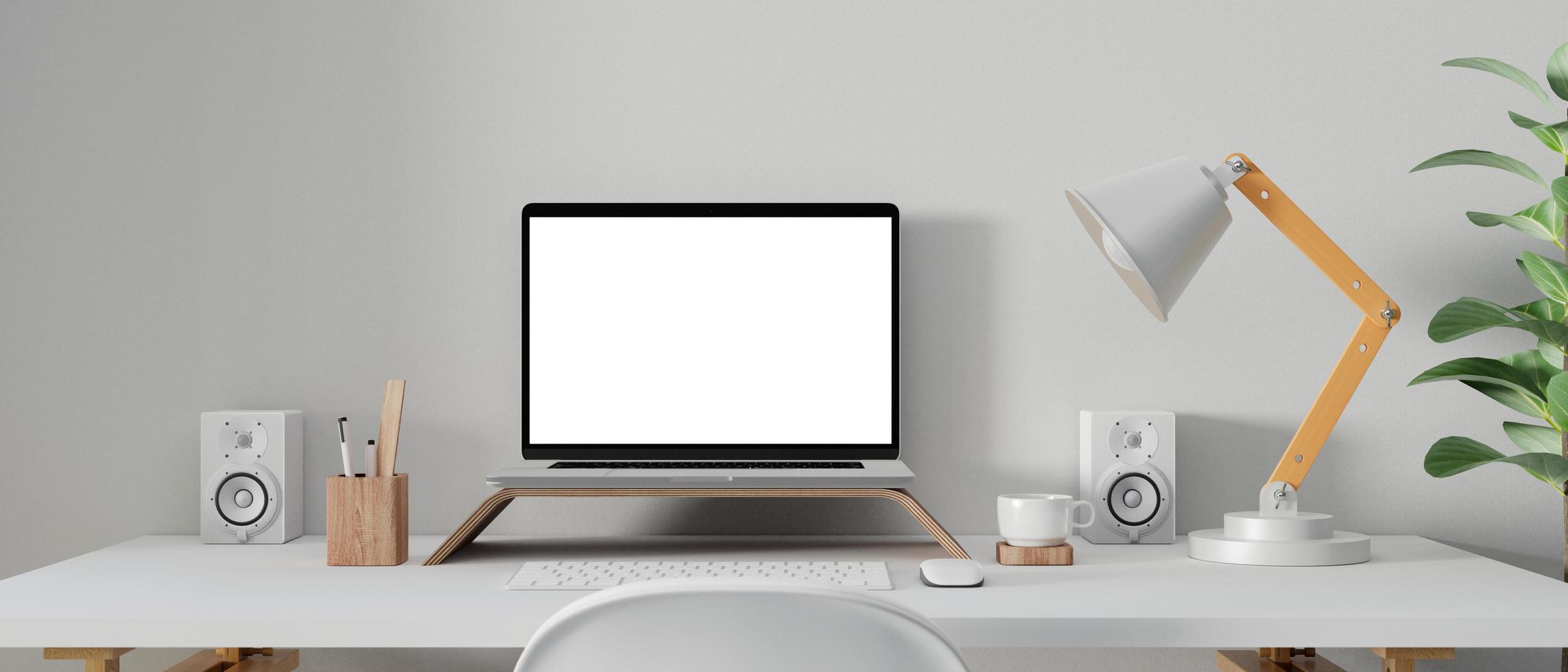 Laptop mockup in workspace photo