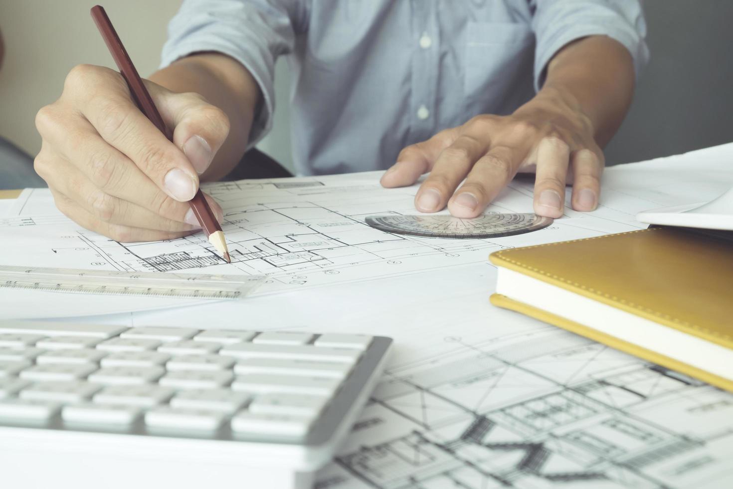 Close-up of architect working on a blueprint photo