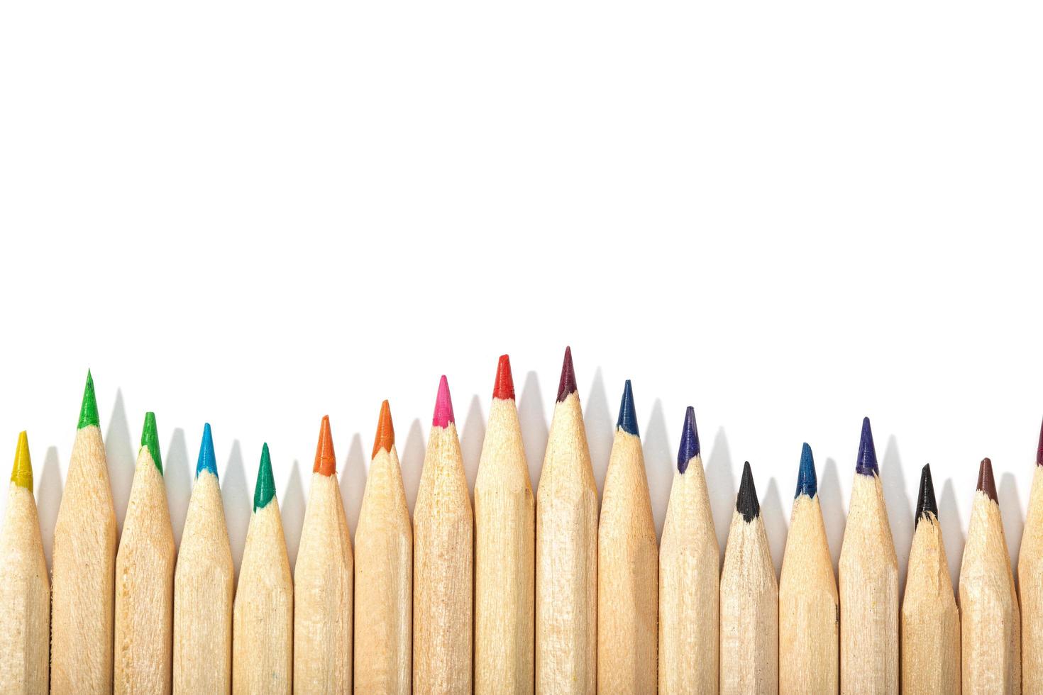 Border of colored pencils on a white background photo