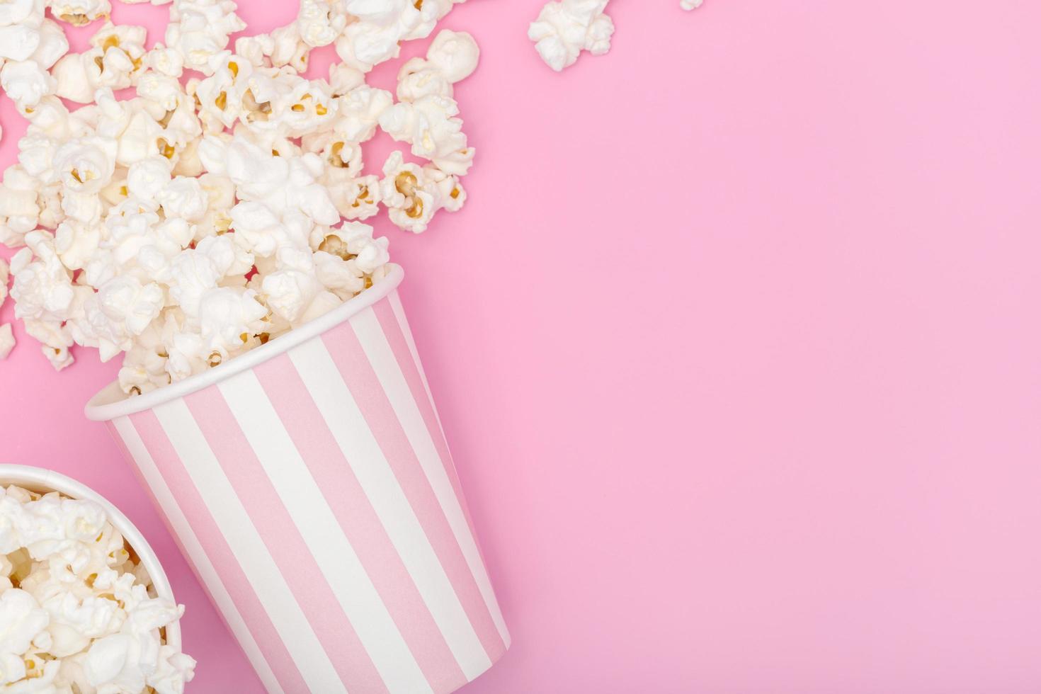 Popcorn bucket on pink background photo