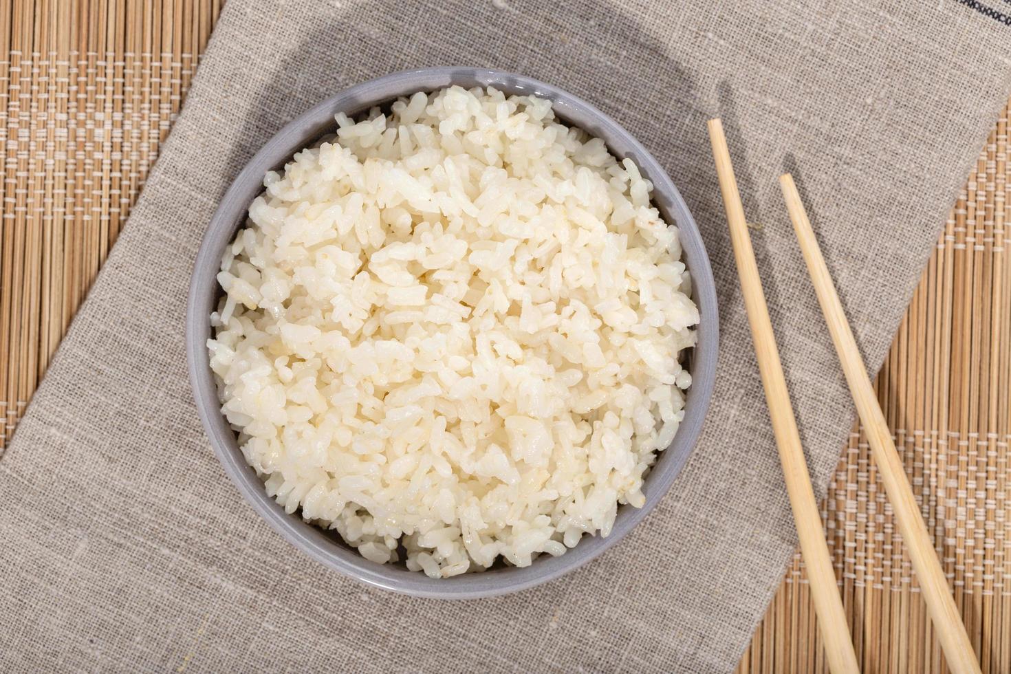Top view of rice in bowl with chop sticks photo