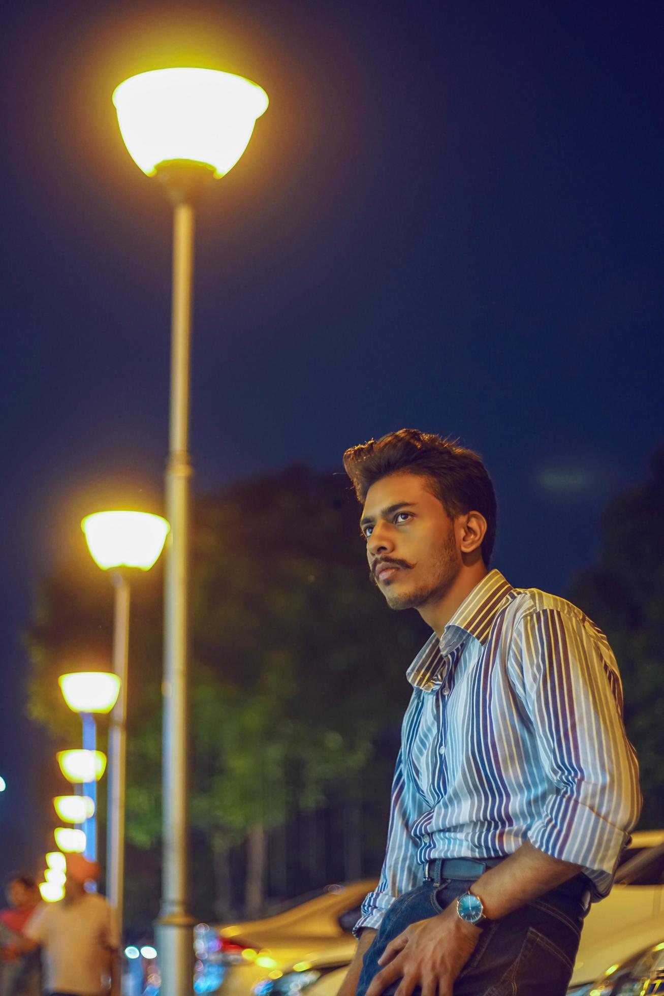 Young man posing near street lights 1270201 Stock Photo at Vecteezy