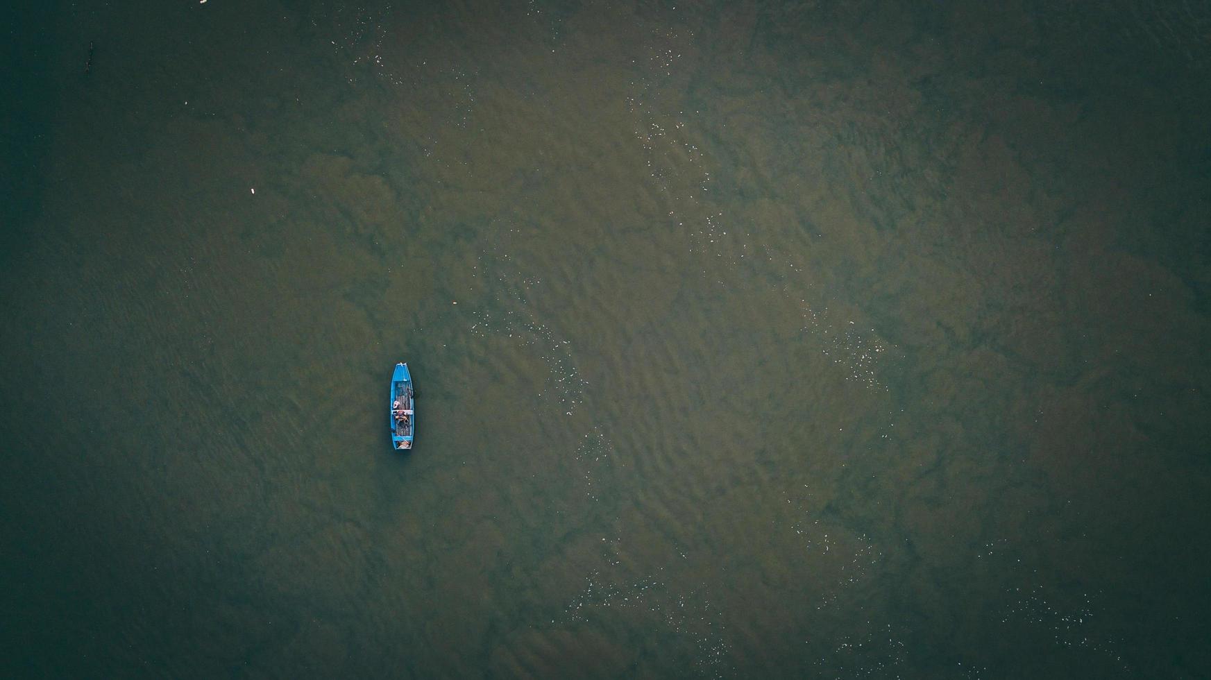 Blue boat on body of water photo