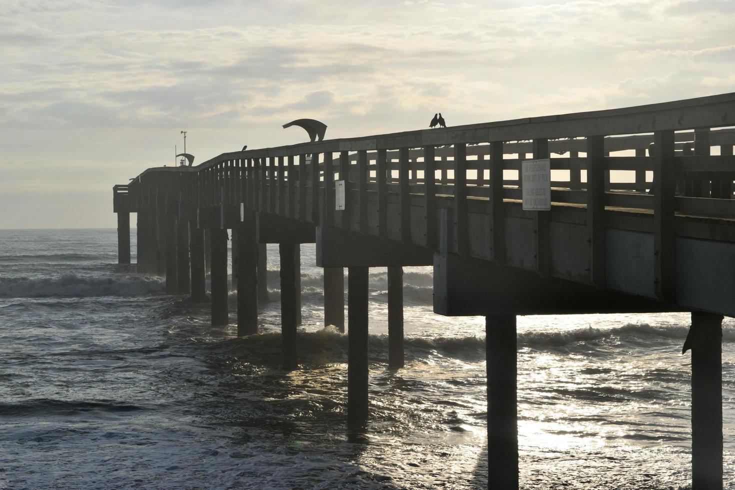 Fishing pier at sunset photo