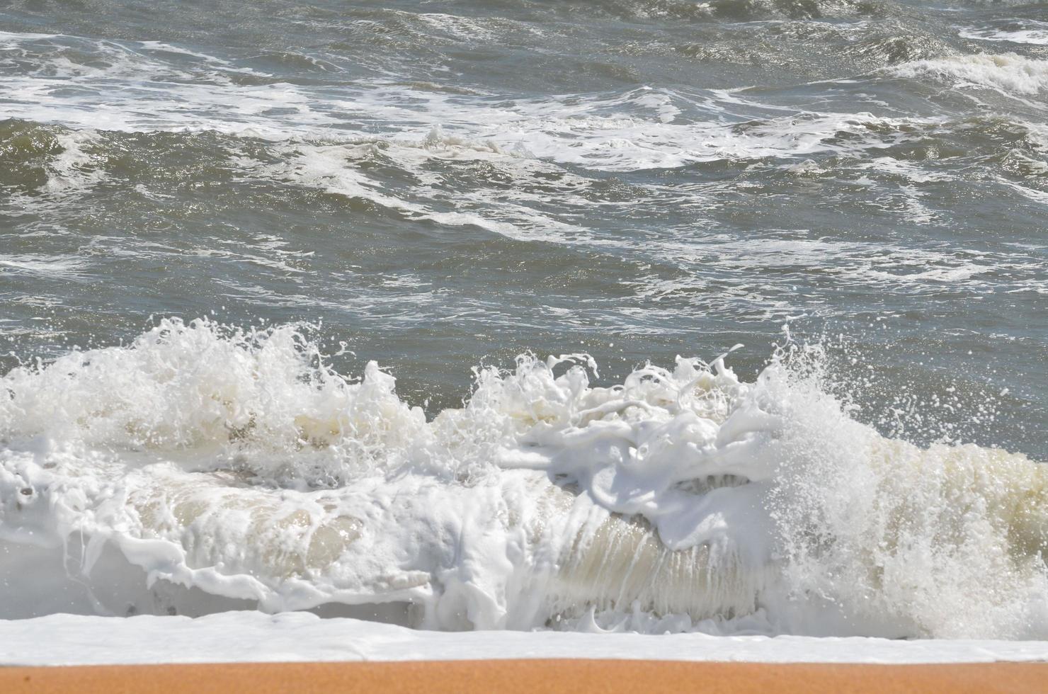 Ocean waves crashing at the beach photo