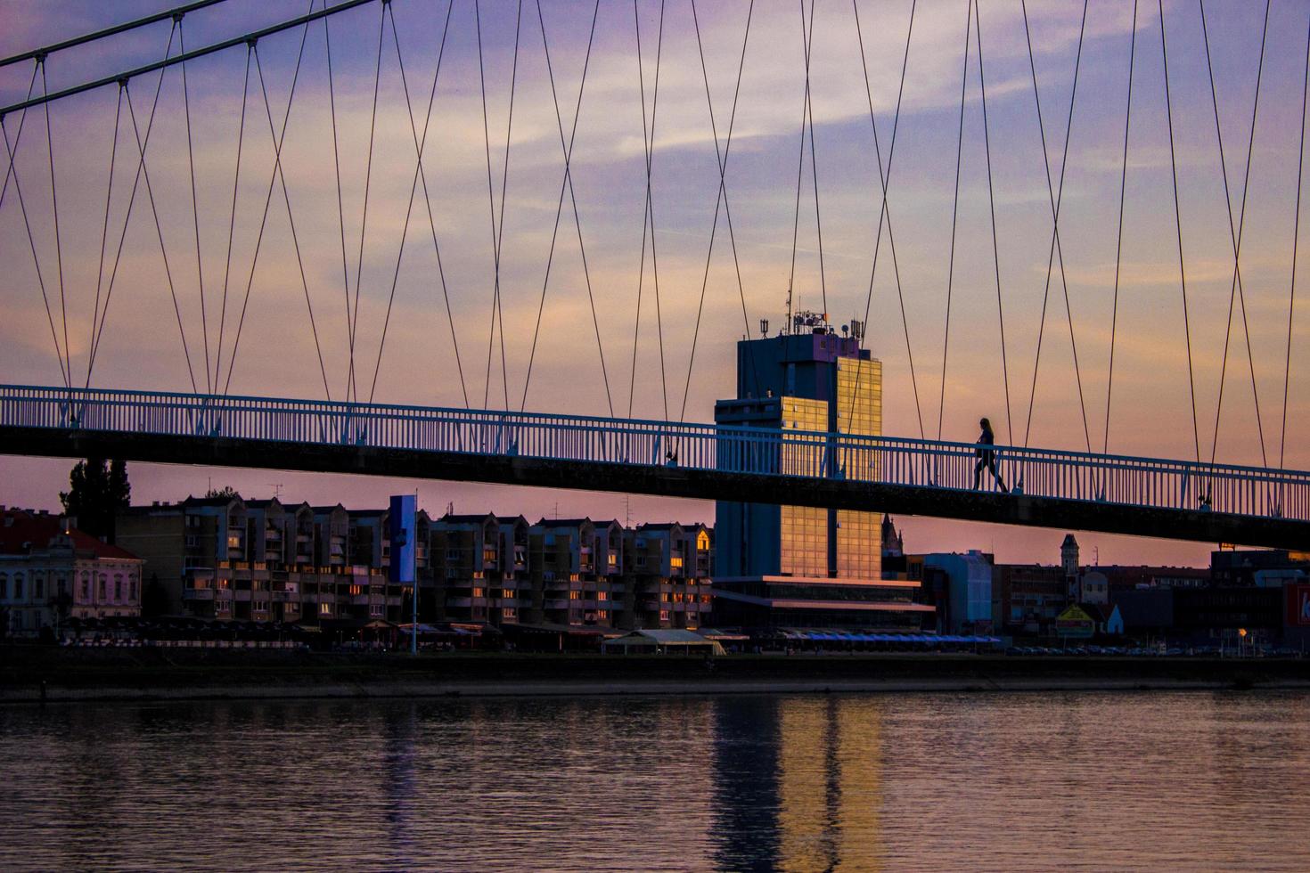 Person walking over a bridge photo