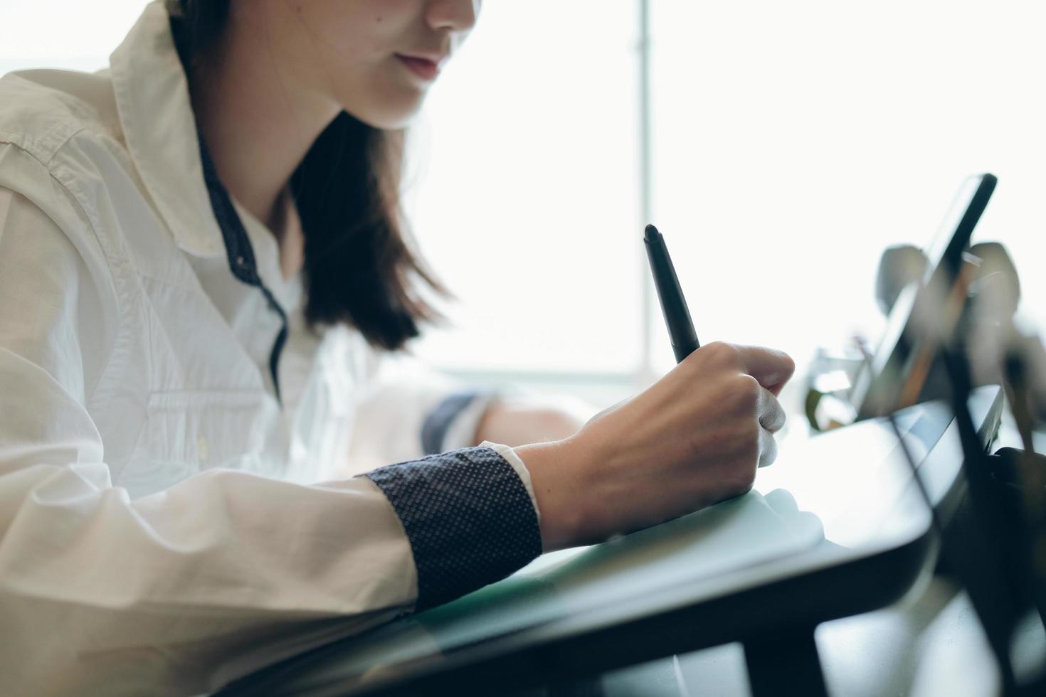 Graphic designer using graphic tablet at desk in the office photo