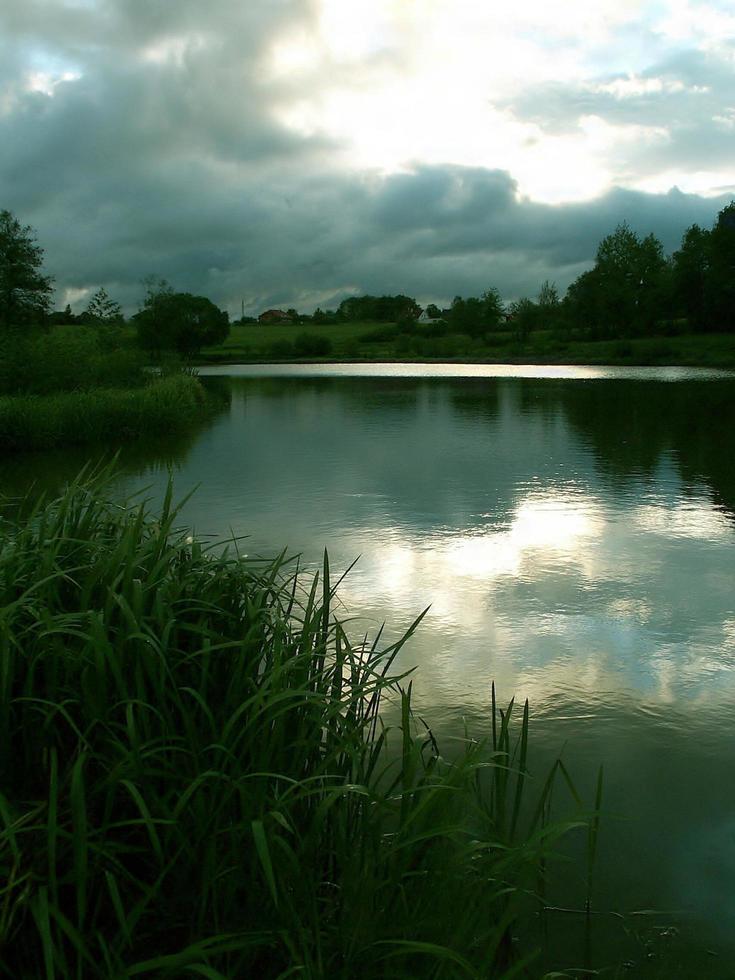 Storm clouds over a pond photo