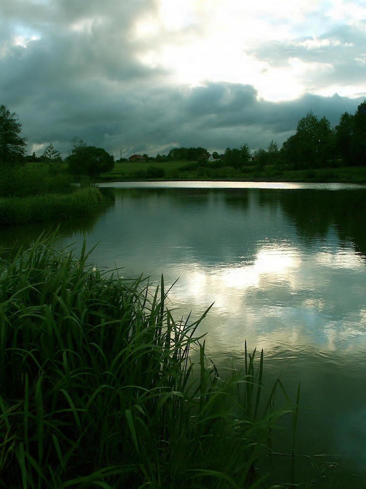 Storm clouds over a pond photo