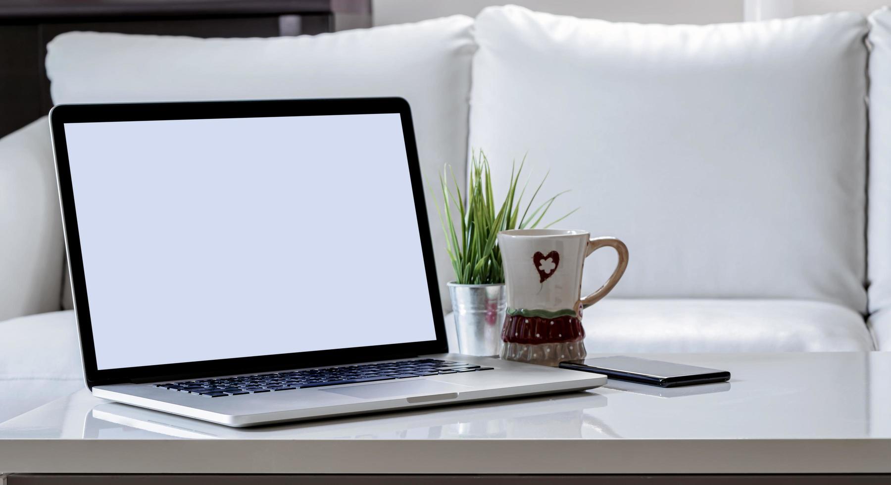 Laptop mockup on a coffee table photo