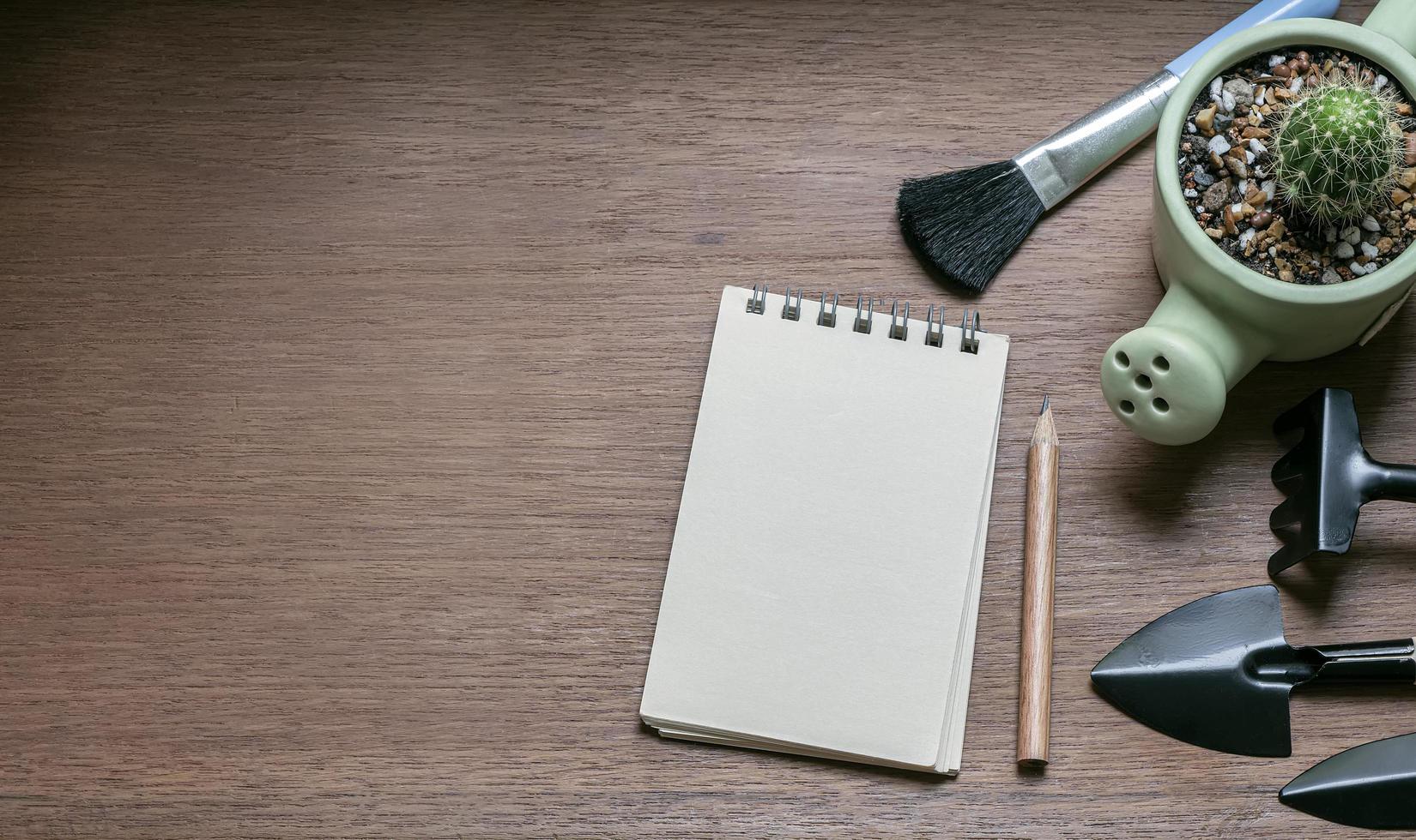 Top view of gardening tools and a notepad photo