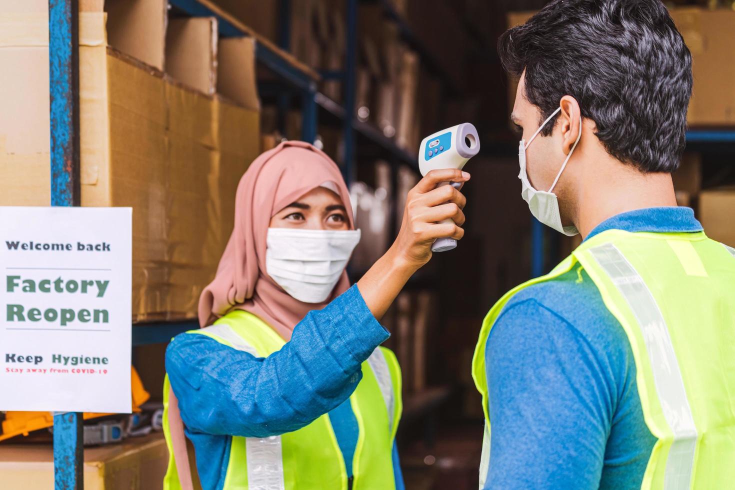 View of a woman checking a man's temperature photo