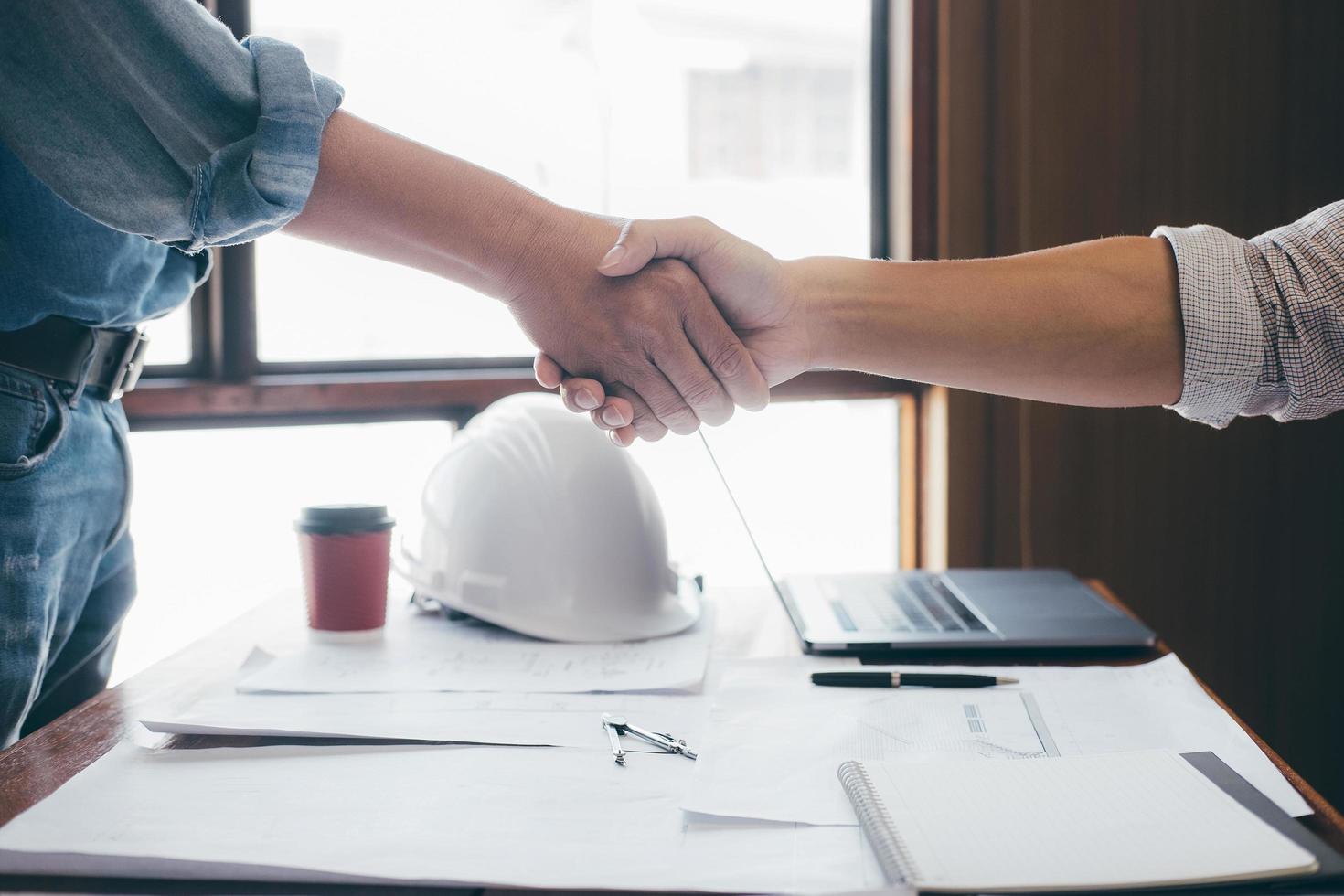 Close-up of two engineers shaking hands photo