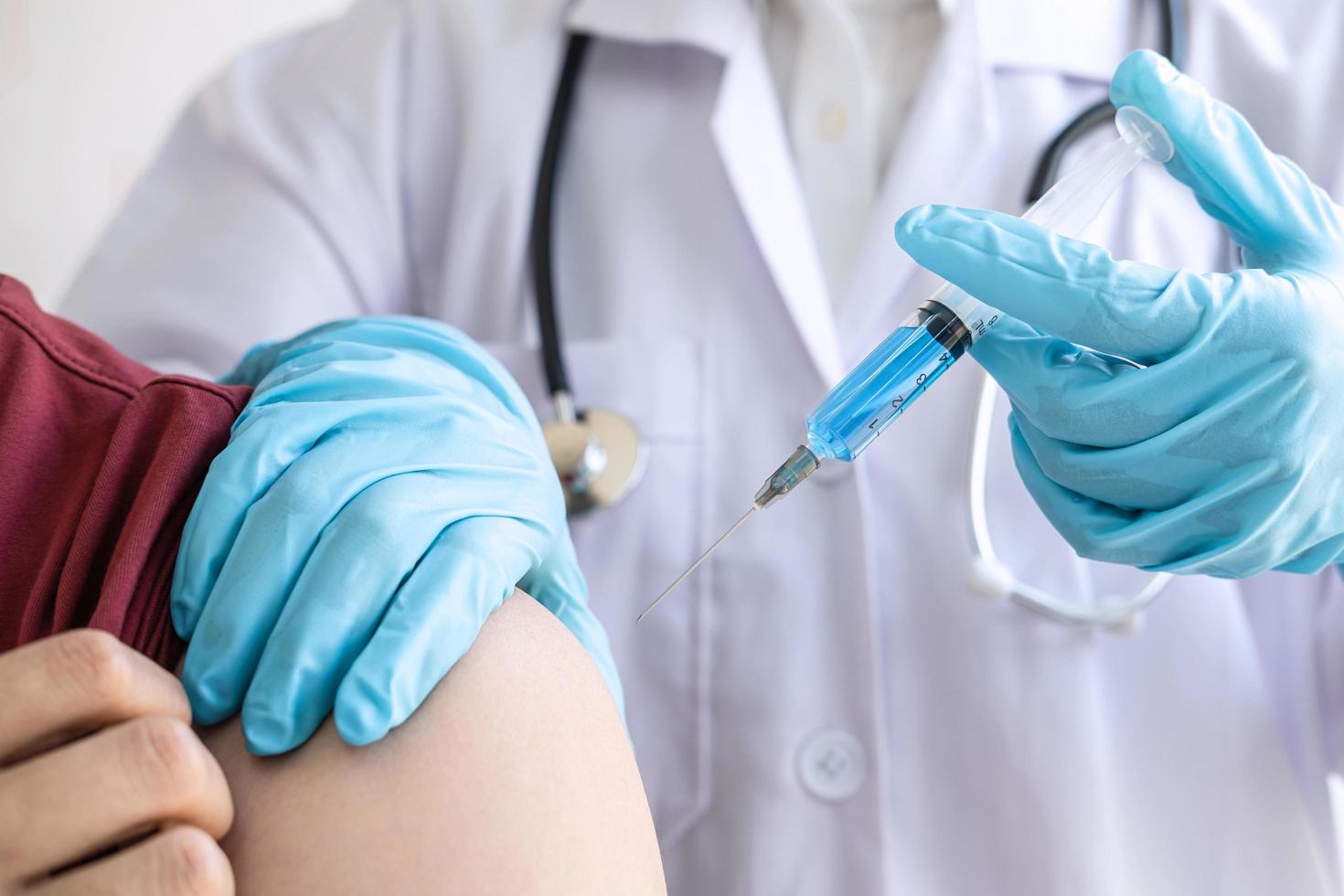 Close-up of a nurse giving a patient a shot photo