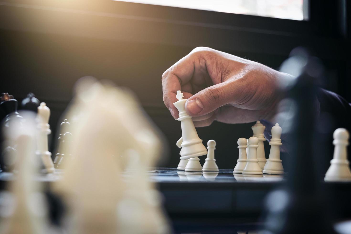 Close-up of a person playing chess photo