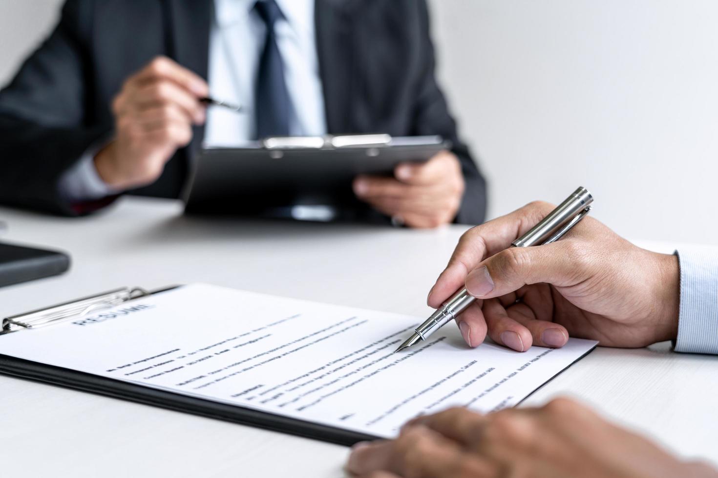 Close-up of a person signing a contract photo