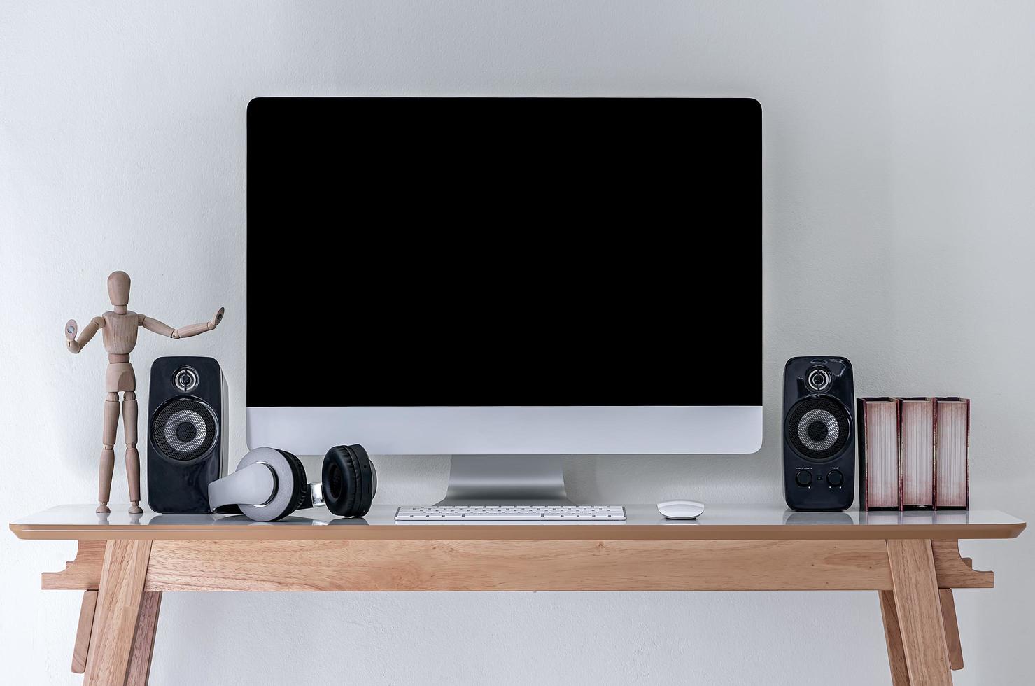 Desktop mockup on a desk with wooden model photo