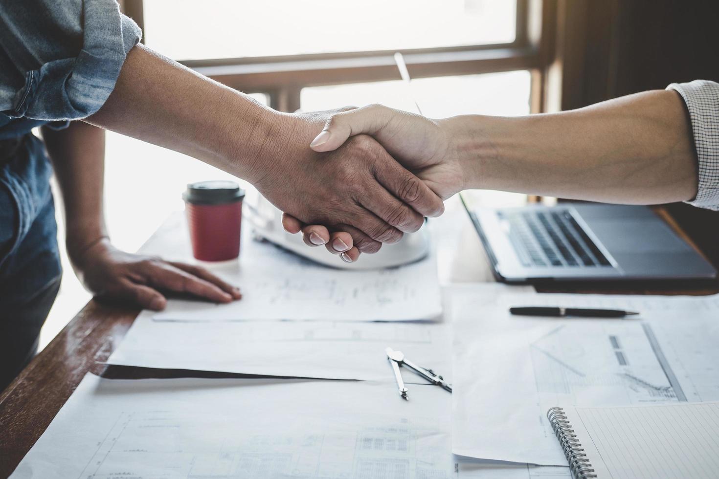 Two people shaking hands in an office photo