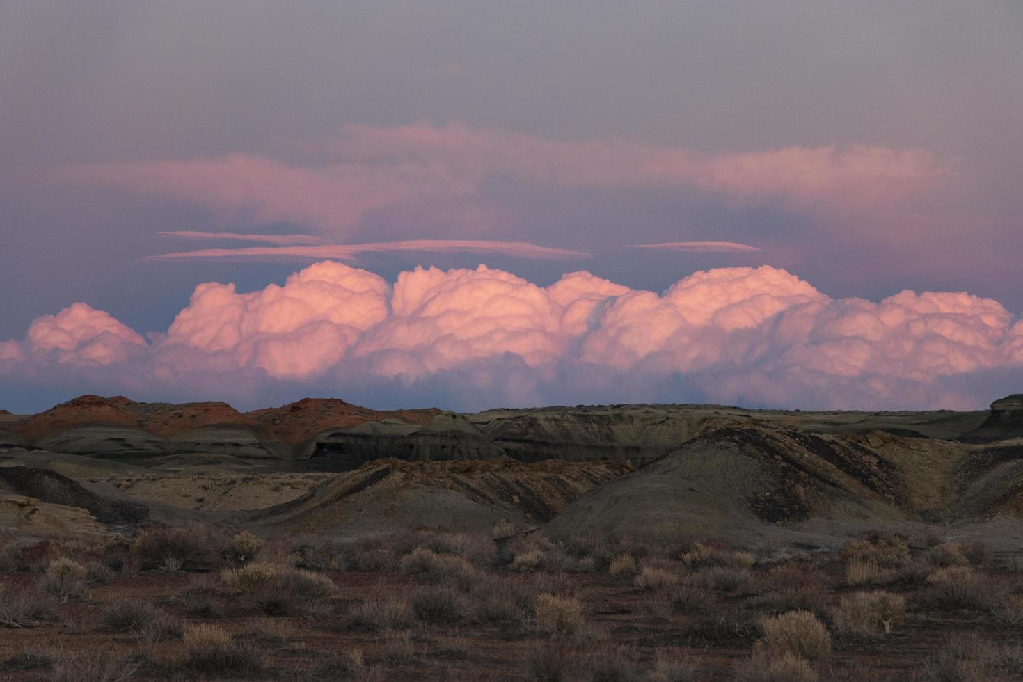 Pink clouds in desert photo