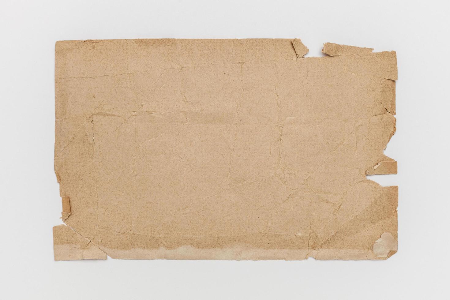 Worn brown paper on a white background photo