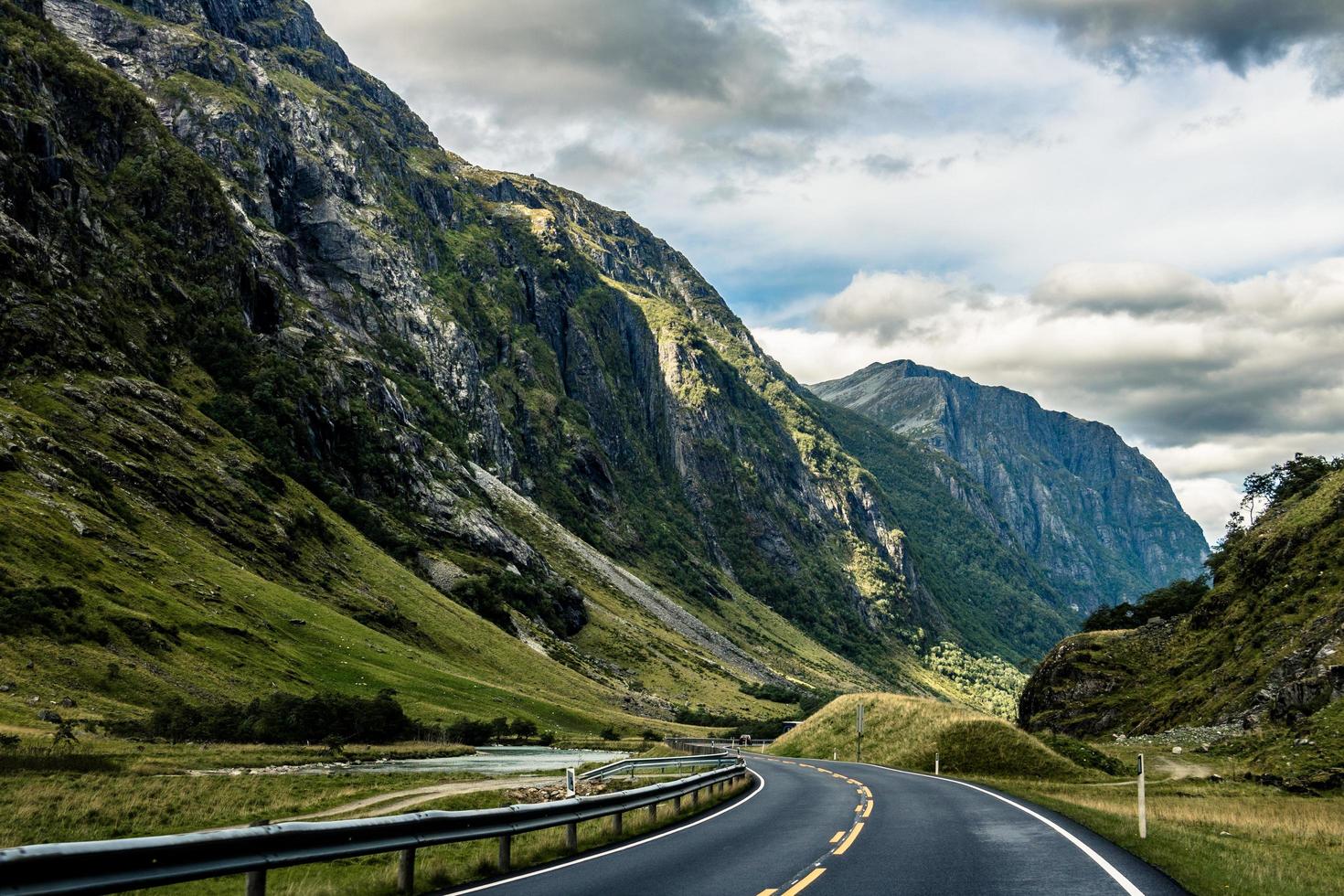 Gray asphalt road between mountains photo