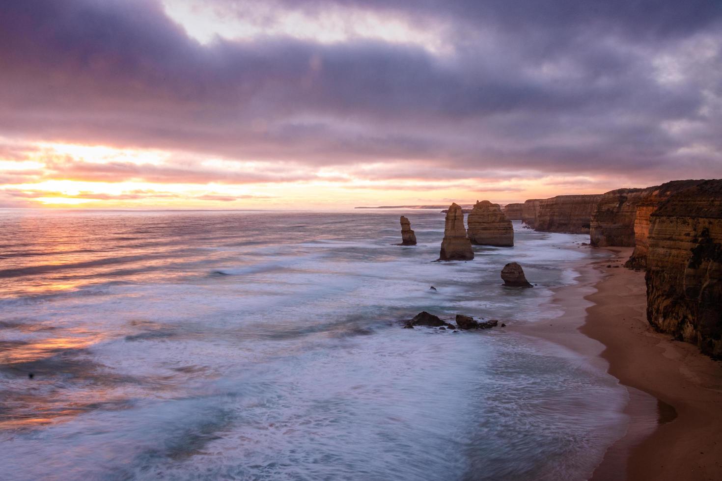 Brown rock formation in the sea  photo