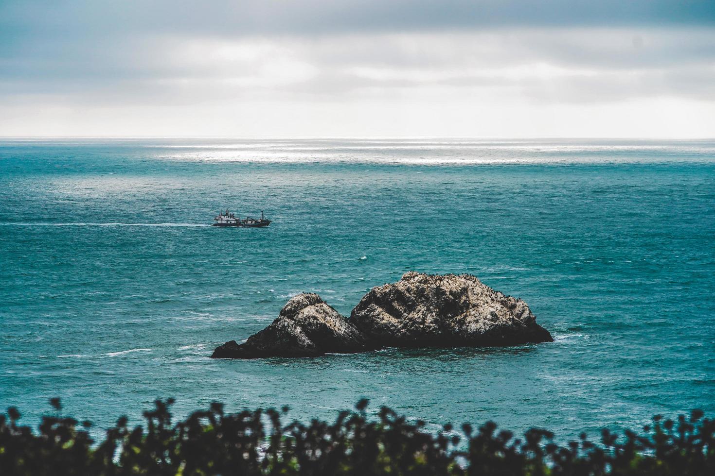 Coastal rock in body of water photo